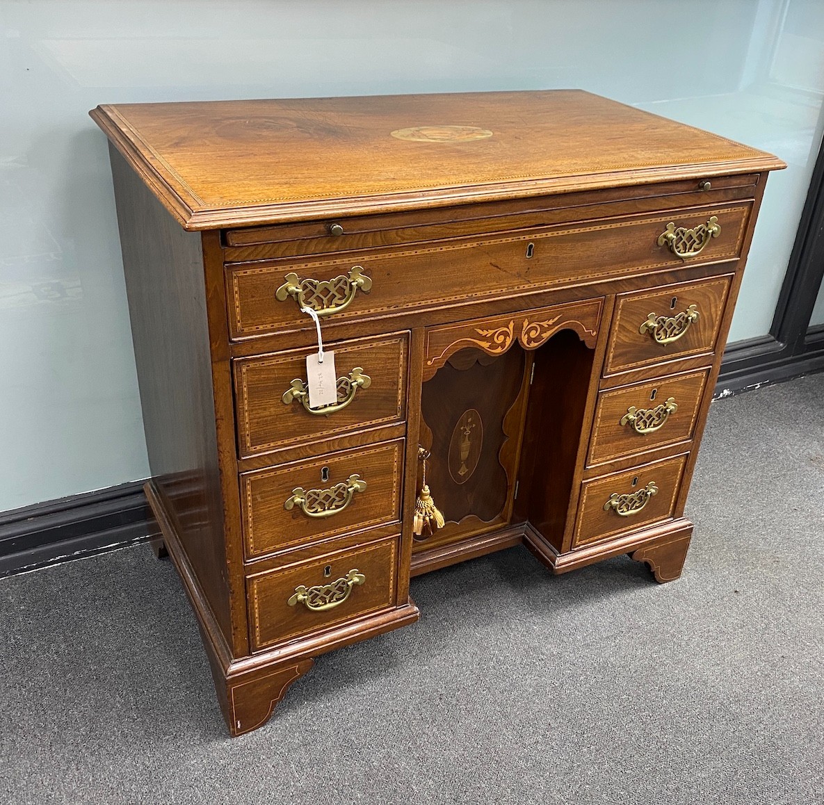 A George III later marquetry inlaid mahogany kneehole desk fitted slide, width 87cm, depth 50cm, height 79cm